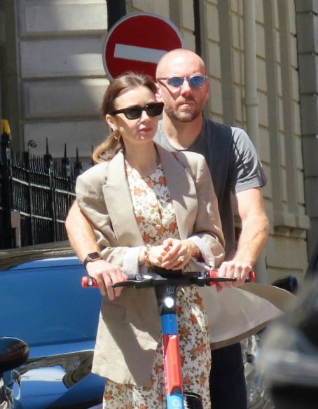 Lily Collins – With hubby Charlie McDowell seen using an electric sharing scooter in Paris