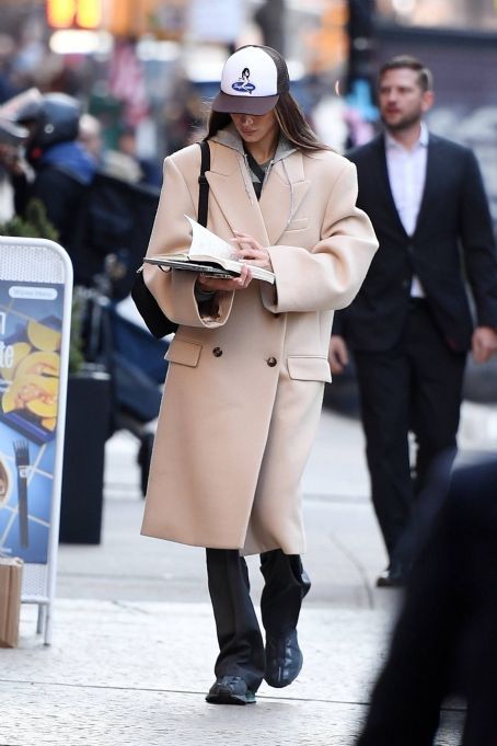 Bella Hadid – Spotted on Manhattan with a trench coat and Salomon sneakers