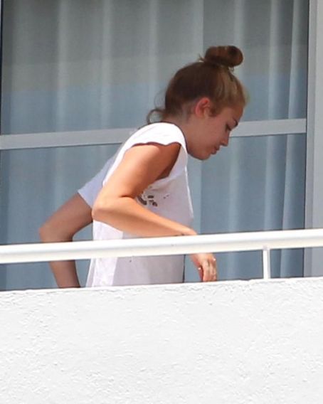 Miley Cyrus Is Spotted On A South Beach Hotel Balcony Wearing A Ripped White T Shirt With No Bra