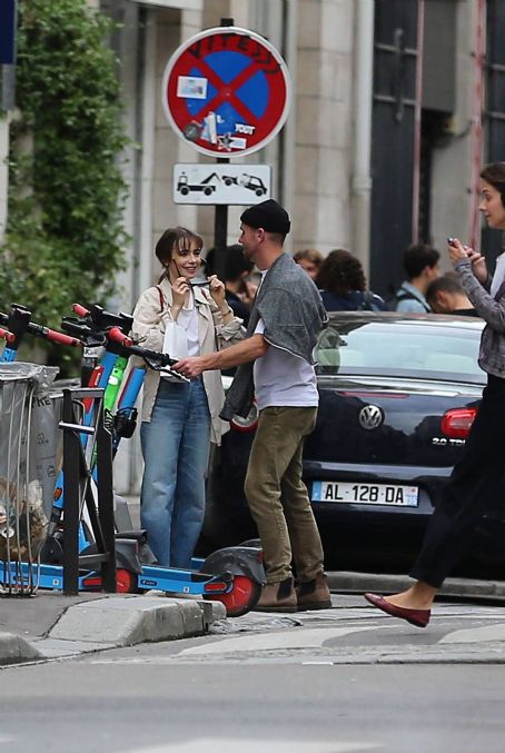 Lily Collins – With new boyfriend Charlie McDowell go for a ride in scooter in Paris