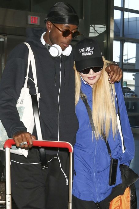 Madonna, cuts a low-key figure as she is supported by her son David Banda at JFK Airport in New York
