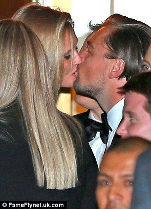 Someone's in the mood for celebrating! Leonardo DiCaprio was seen kissing girlfriend Toni Garrn at the CAA Golden Globes after party on Sunday night