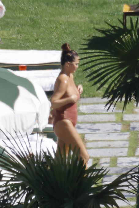 Chrissy Teigen – Seen by a swimming pool in Lake Como