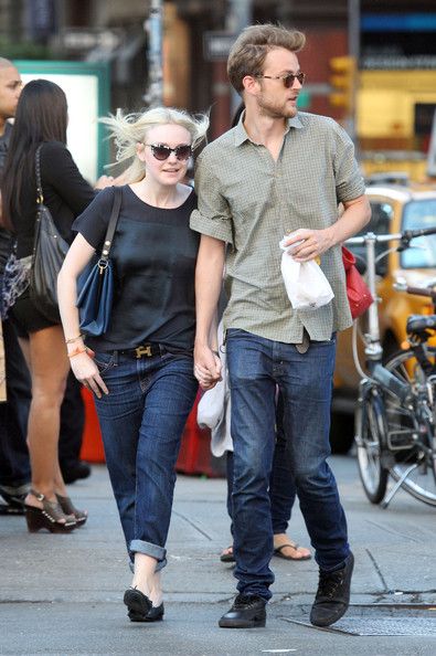A smitten looking Dakota Fanning and her boyfriend Jamie Strachan go hand in hand for a stroll around New York City