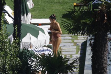 Chrissy Teigen – Seen by a swimming pool in Lake Como