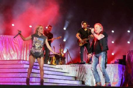 INDIO, CALIFORNIA - APRIL 30: Axl Rose of Guns N' Roses performs onstage with Carrie Underwood during Day 2 of the 2022 Stagecoach Festival at the Empire Polo Field