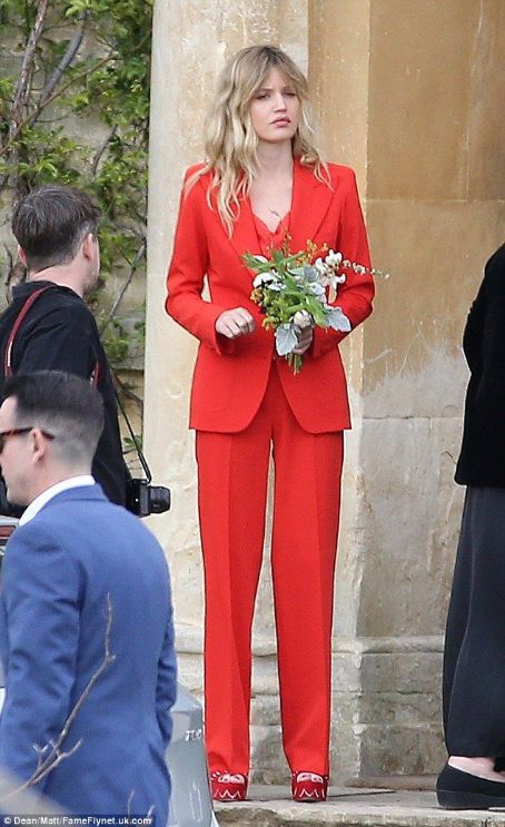 PICTURE EXCLUSIVE: Rock 'n' roll bridesmaid Georgia May Jagger looks the picture of cool in red jacket and tailored trousers at her brother James' wedding