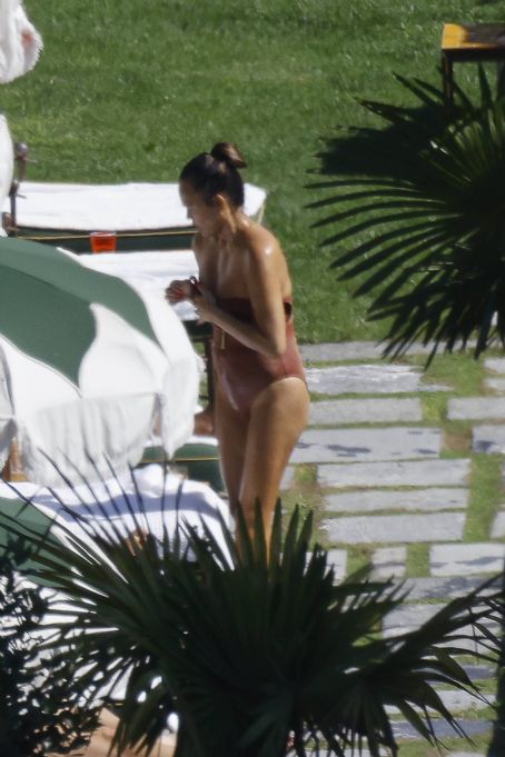Chrissy Teigen – Seen by a swimming pool in Lake Como
